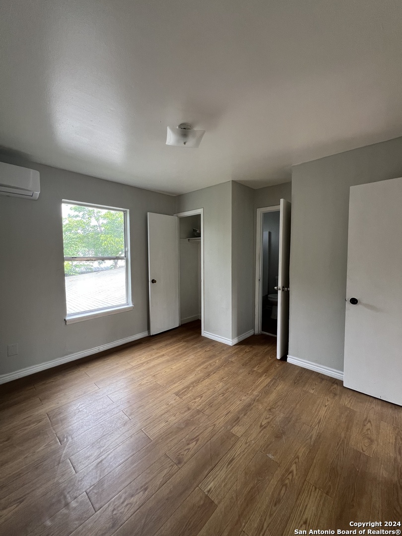 1723 West Mayfield Boulevard, Unit 5 San Antonio, TX 78211 - Photo 7 of 13 an empty room with windows and closet