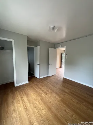 a view of an empty room and wooden floor