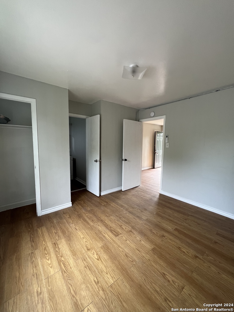 1723 West Mayfield Boulevard, Unit 5 San Antonio, TX 78211 - Photo 8 of 13 a view of an empty room and wooden floor