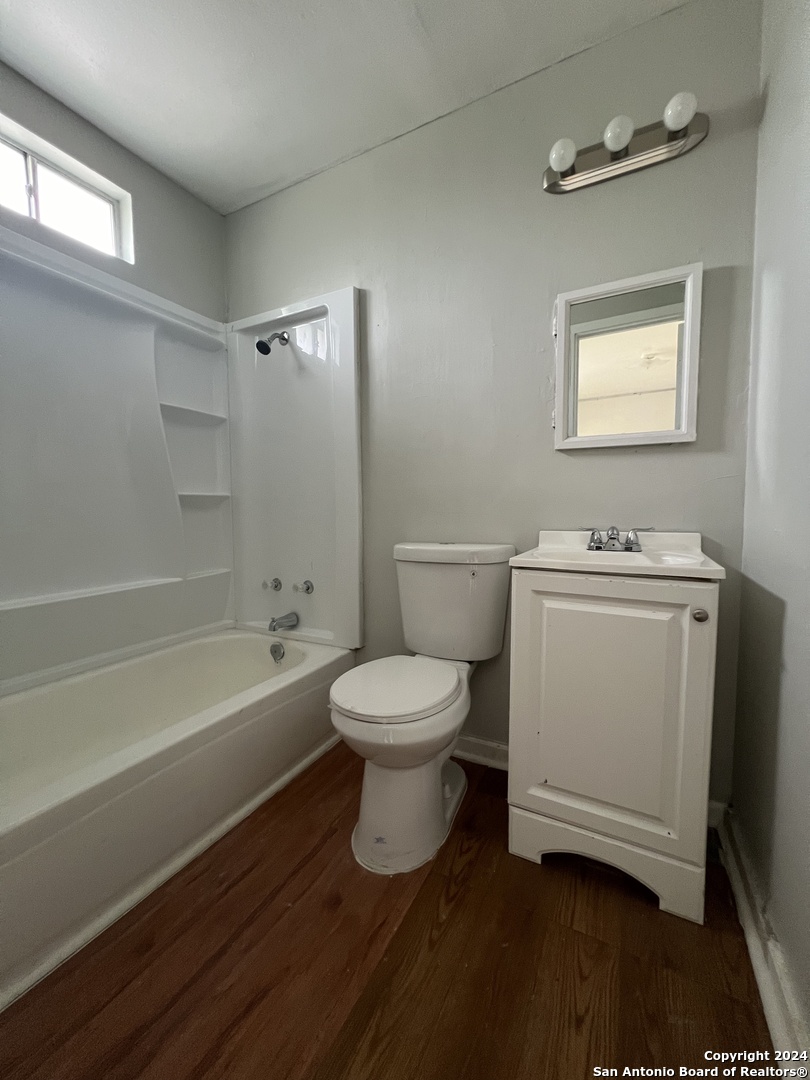 1723 West Mayfield Boulevard, Unit 5 San Antonio, TX 78211 - Photo 9 of 13 a bathroom with a toilet a sink and bathtub