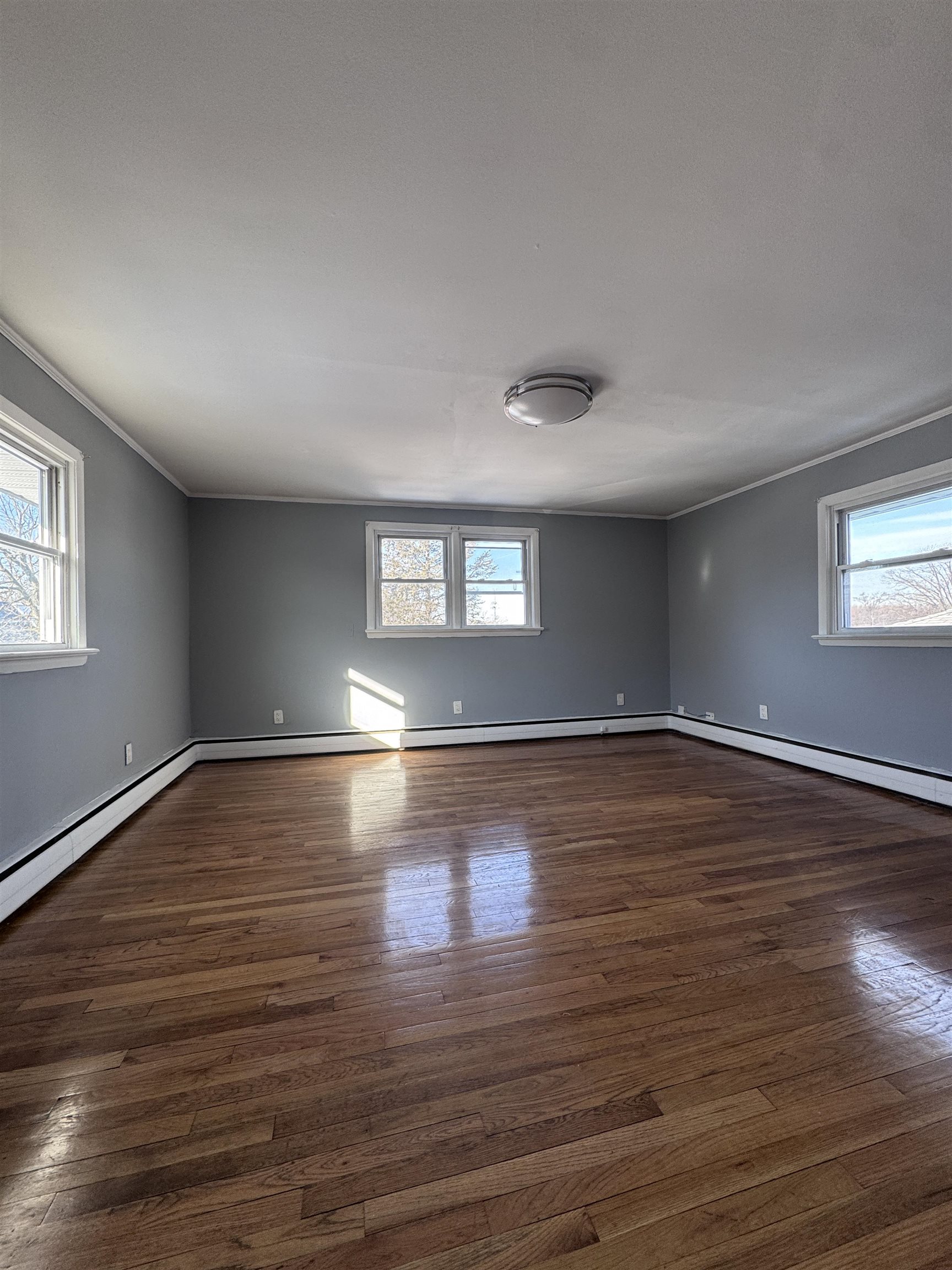 1624 Teaneck Road, Unit 2 Teaneck, NJ 07666 - Photo 4 of 7 a view of empty room with wooden floor and fan