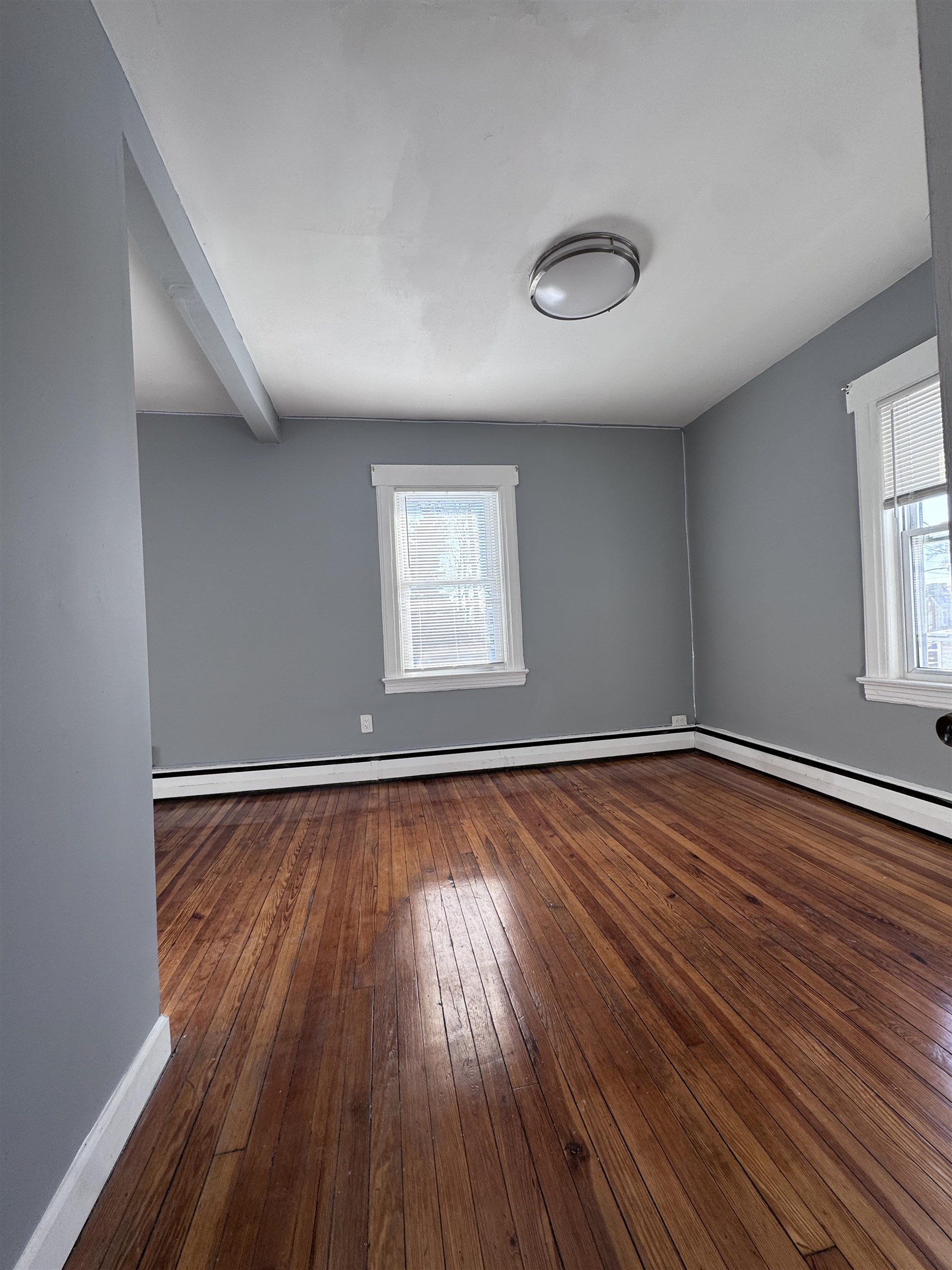 1624 Teaneck Road, Unit 2 Teaneck, NJ 07666 - Photo 7 of 7 an empty room with wooden floor and windows