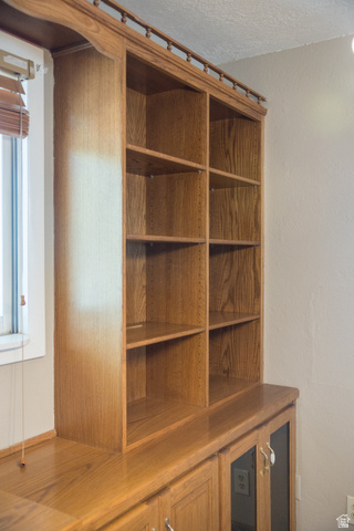 634 South 2100th Street West Vernal, UT 84078 - Photo 6 of 71 Built-in wood-finish cabinetry featuring open shelving, base storage with glass-front doors, and a wood-finish countertop