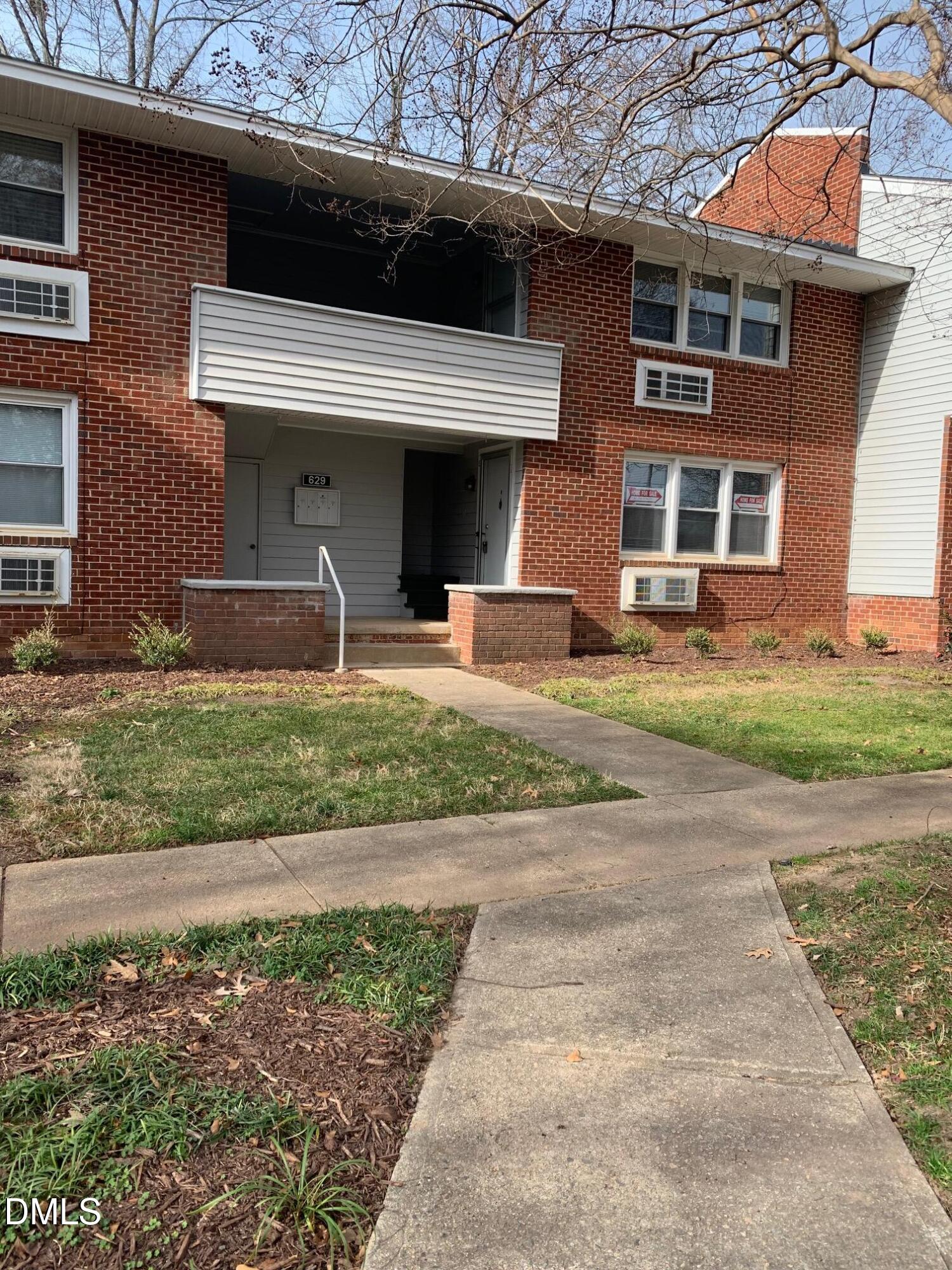629 Daniels Street, Unit B Raleigh, NC 27605 - Photo 2 of 8 a front view of a house with garden and parking