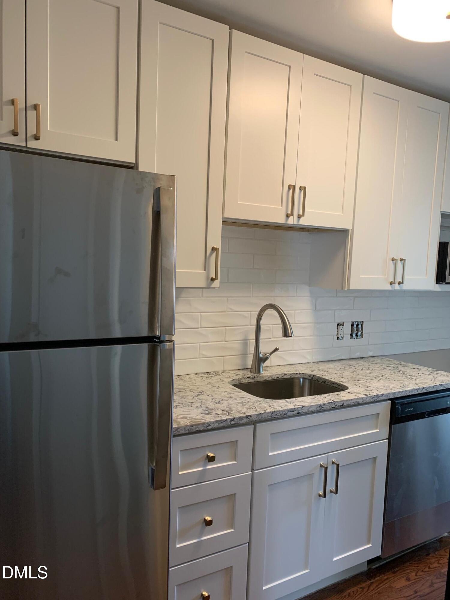 629 Daniels Street, Unit B Raleigh, NC 27605 - Photo 4 of 8 a kitchen with appliances a sink and cabinets