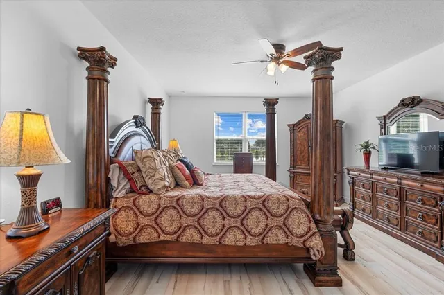 a bedroom with a bed a dresser and window