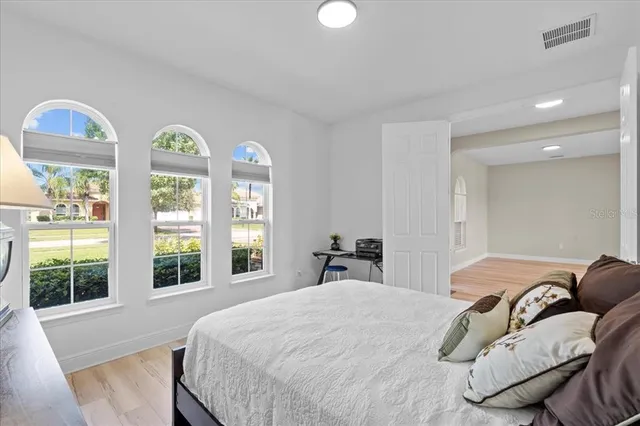 a bedroom with a bed and a large window