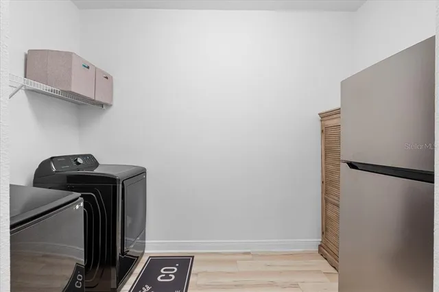 a view of storage and utility room with washer and dryer