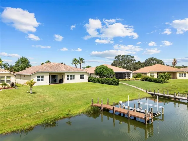 a swimming pool with outdoor seating and yard