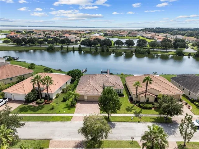 an aerial view of a house with outdoor space and lake view