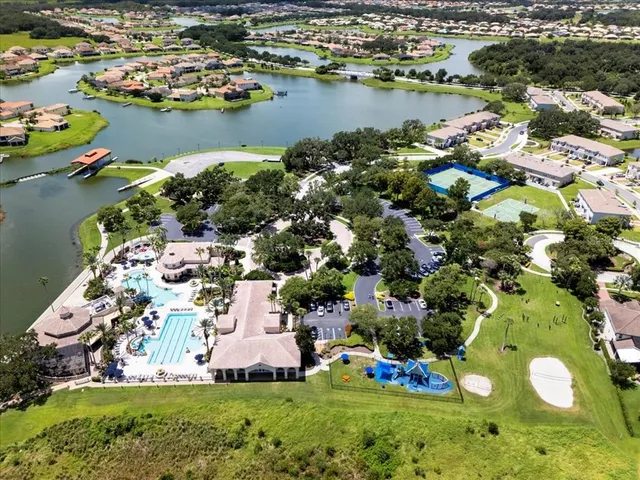 an aerial view of a house with a garden and lake view
