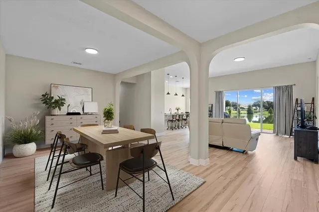 a view of a dining room with furniture window and wooden floor