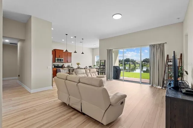 a living room with furniture and a floor to ceiling window