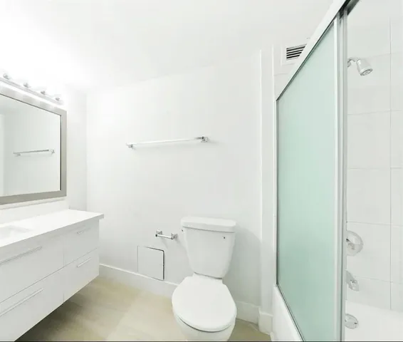 a white toilet sitting next to a bathroom sink
