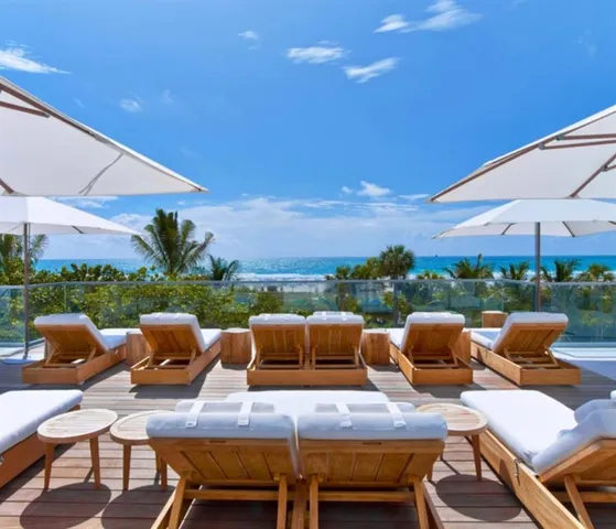 a roof deck with table and chairs