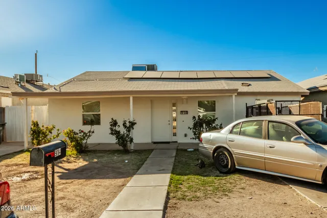 a view of a car park in front of house