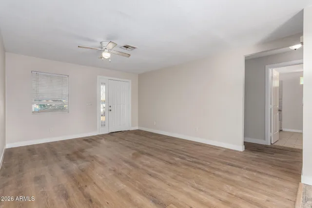 wooden floor in an empty room with a window