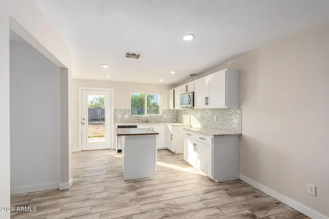 a kitchen with stainless steel appliances granite countertop a sink stove and cabinets