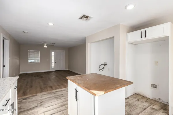 a kitchen with granite countertop a sink and a stove top oven