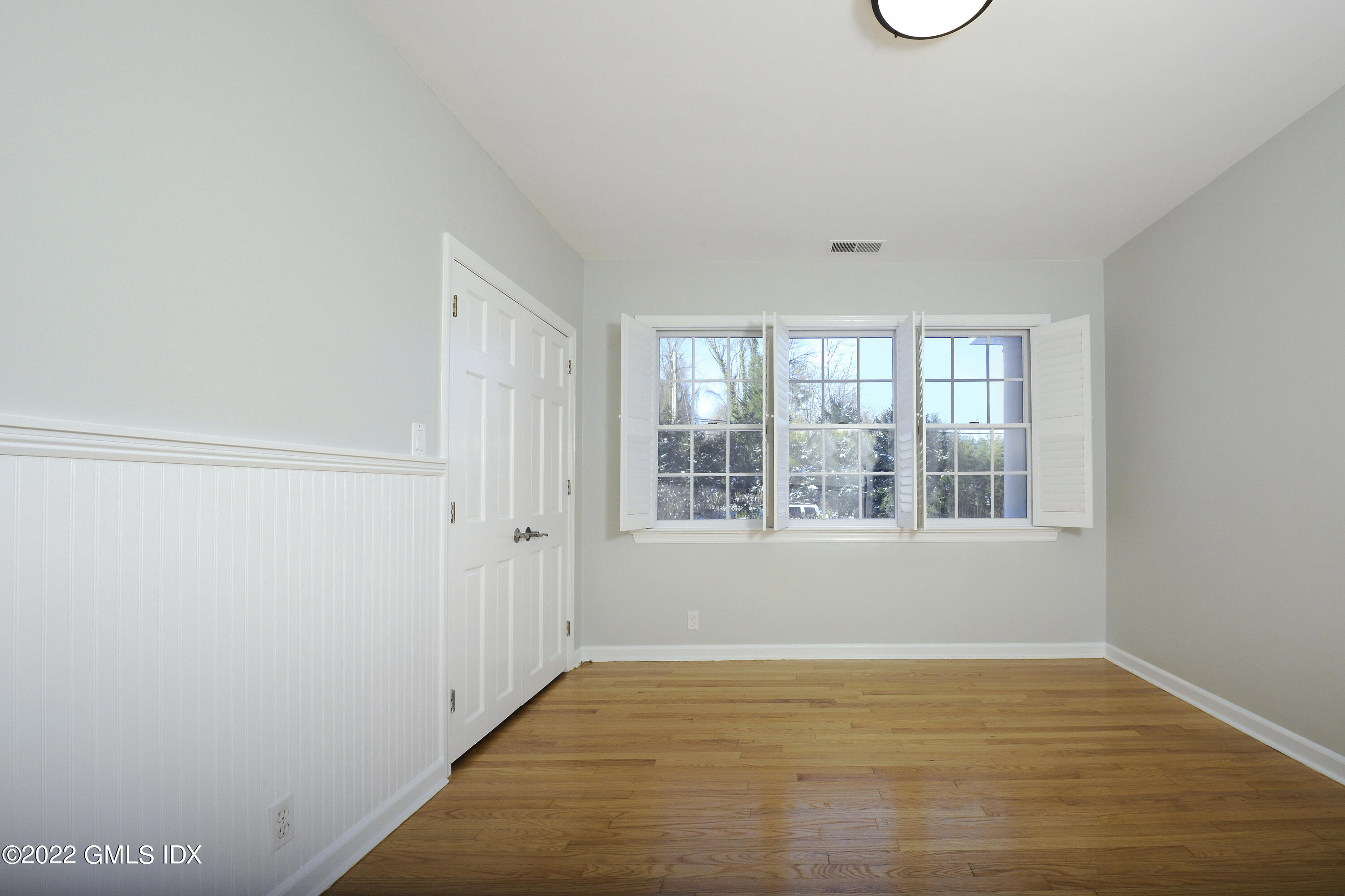 5 Anderson Road Greenwich, CT 06830 - Photo 18 of 31 a view of an empty room with wooden floor and a window