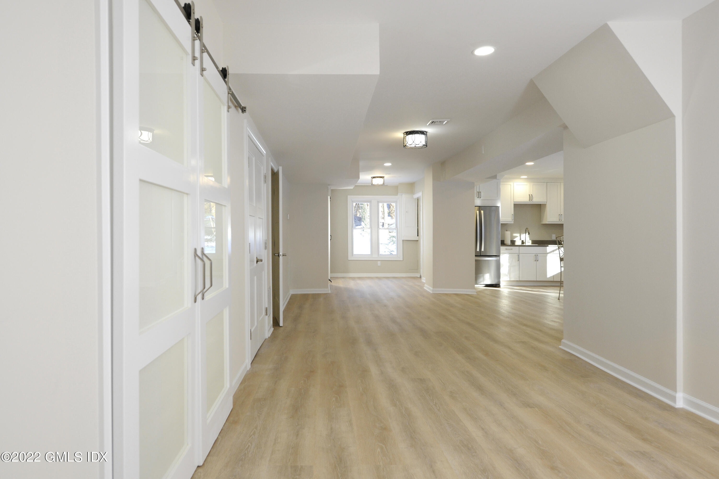 5 Anderson Road Greenwich, CT 06830 - Photo 24 of 31 a view of a hallway with wooden floor and a kitchen