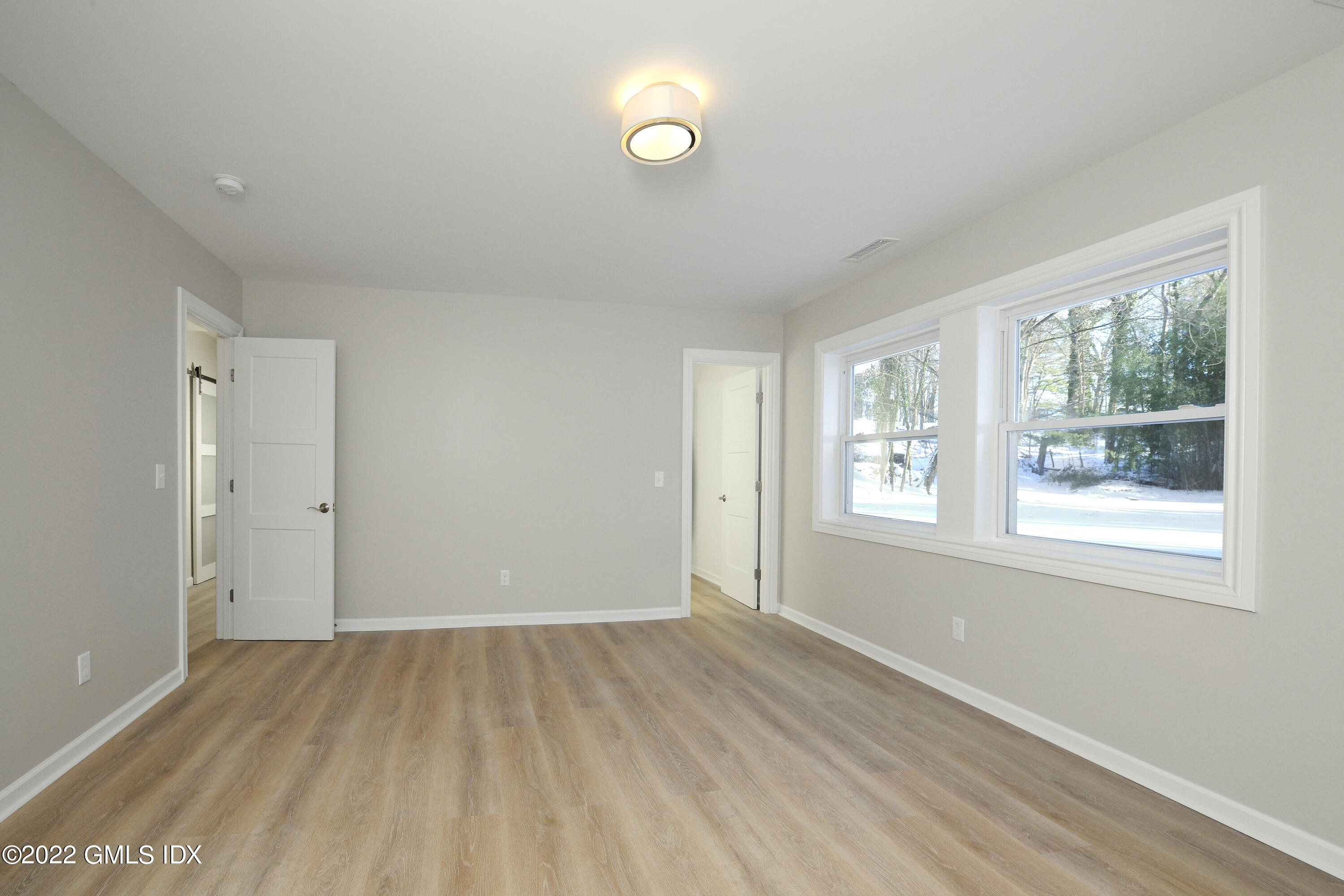 5 Anderson Road Greenwich, CT 06830 - Photo 25 of 31 a view of an empty room with wooden floor and a window