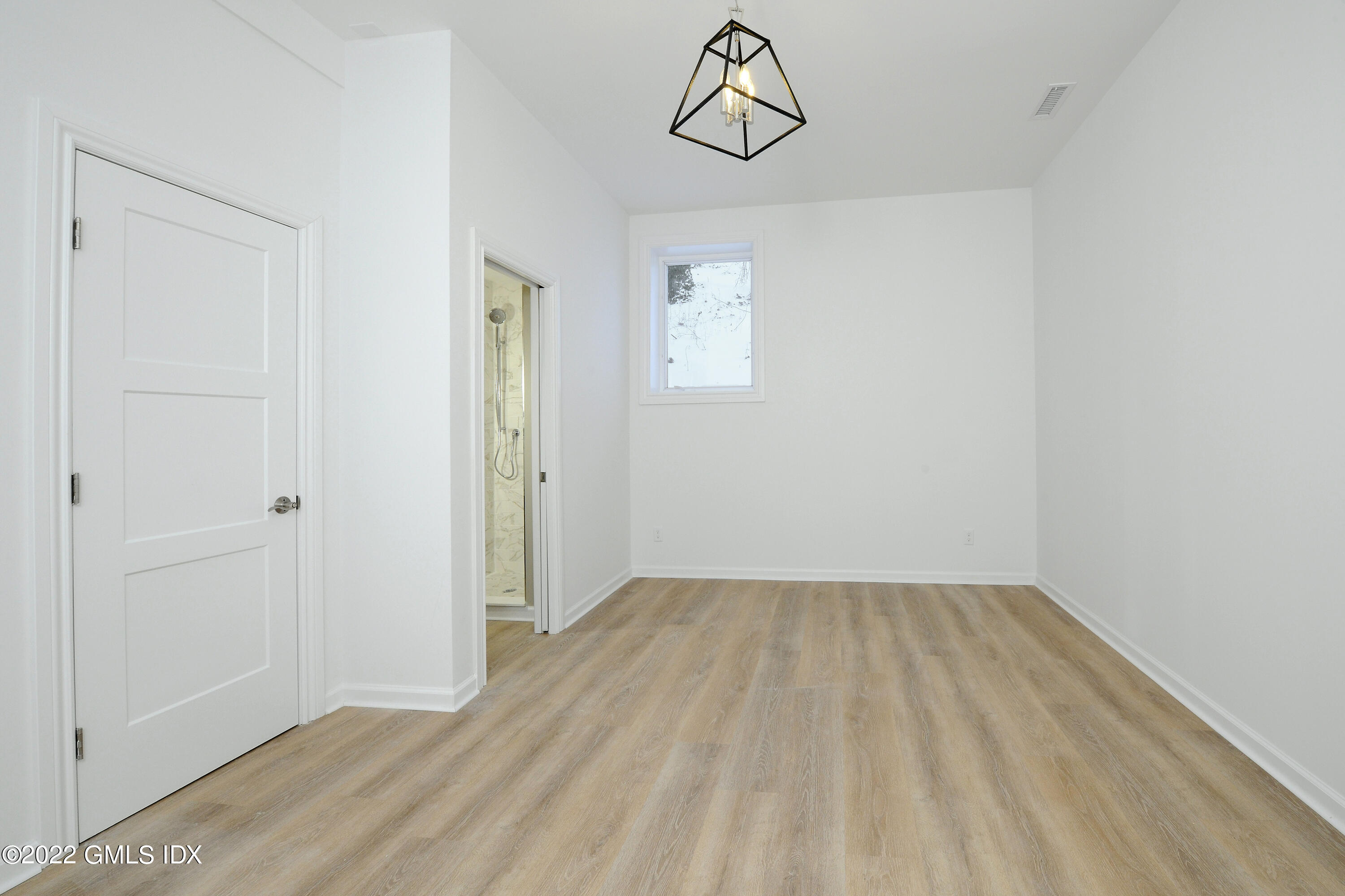 5 Anderson Road Greenwich, CT 06830 - Photo 27 of 31 a view of a room with a hanging light and hardwood