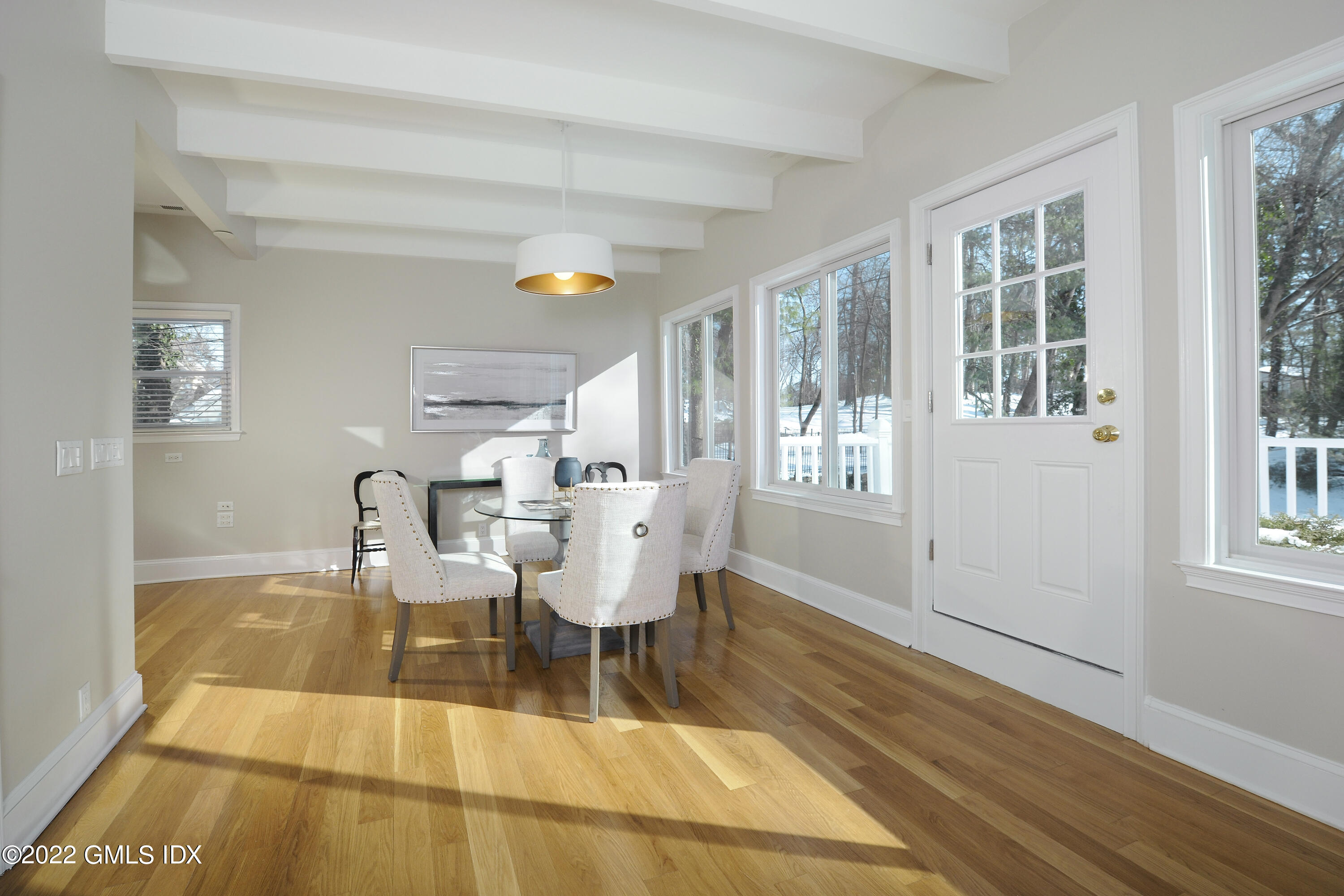 5 Anderson Road Greenwich, CT 06830 - Photo 10 of 31 a dining room with wooden floor and a floor to ceiling window