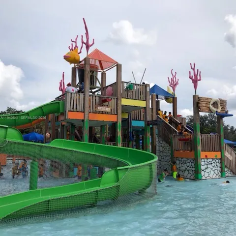 a view of street with a bench and trees