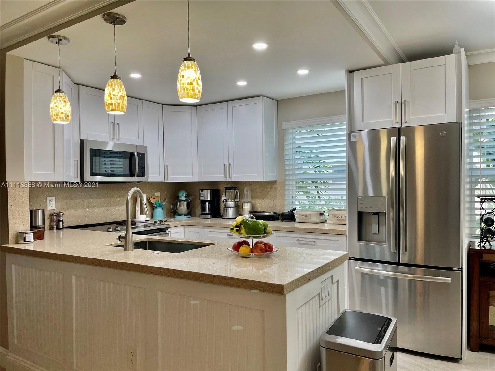 Kings Point Piedmont Delray Beach, FL 33484 - Photo 13 of 22 a kitchen with a sink stainless steel appliances and refrigerator