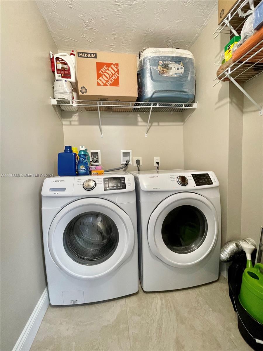 Kings Point Piedmont Delray Beach, FL 33484 - Photo 15 of 22 a utility room with dryer and washer