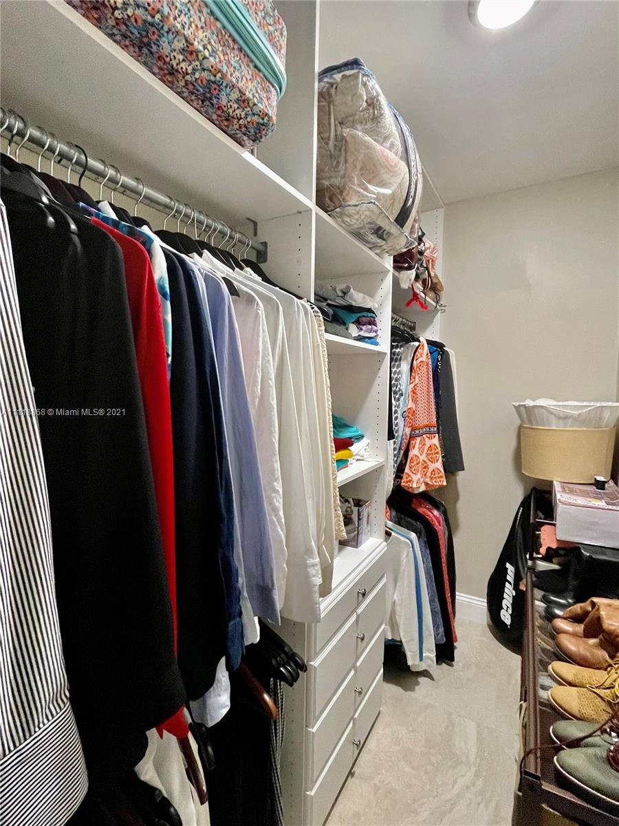 Kings Point Piedmont Delray Beach, FL 33484 - Photo 16 of 22 a view of walk in closet with clothes and shoes