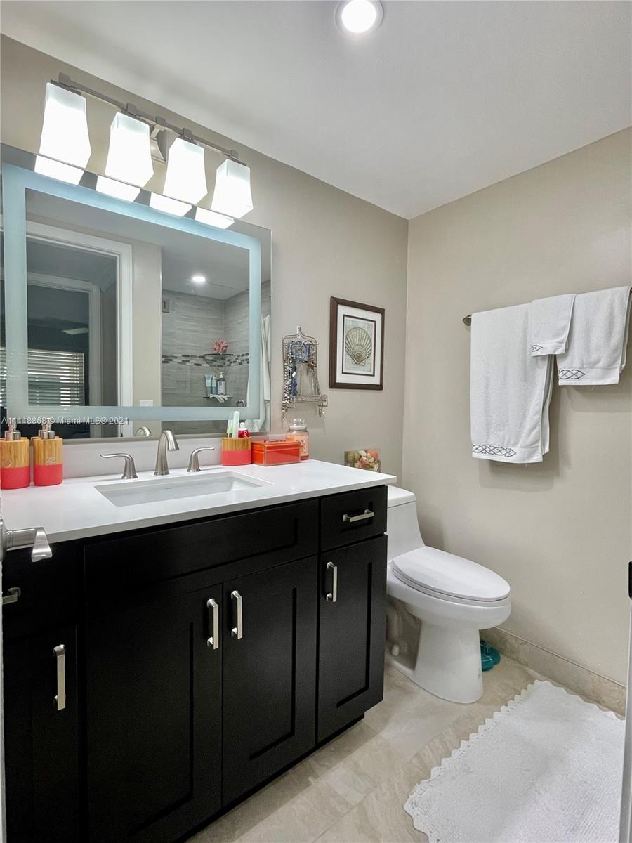 Kings Point Piedmont Delray Beach, FL 33484 - Photo 18 of 22 a bathroom with a sink and a mirror