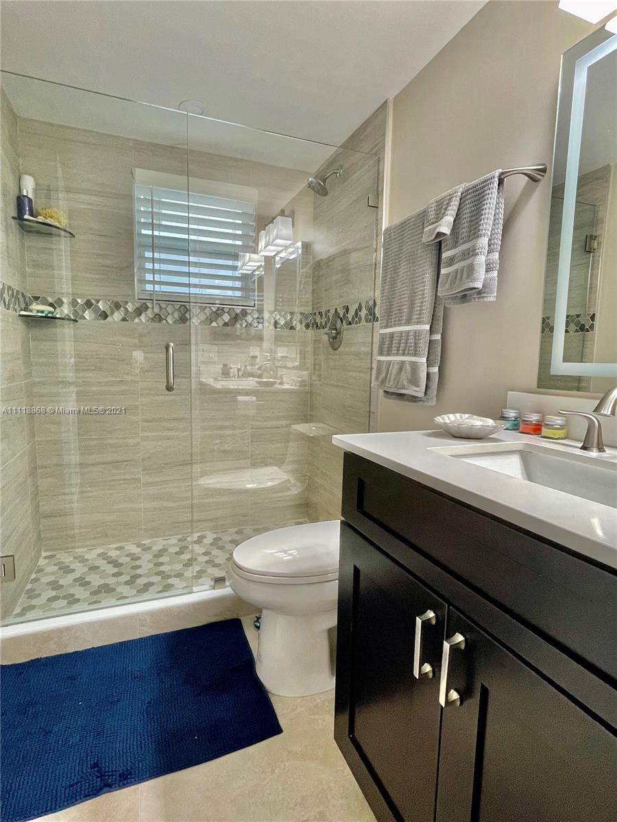 Kings Point Piedmont Delray Beach, FL 33484 - Photo 21 of 22 a bathroom with a sink a toilet and shower