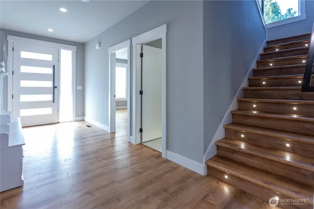 a view of entryway and hall with wooden floor