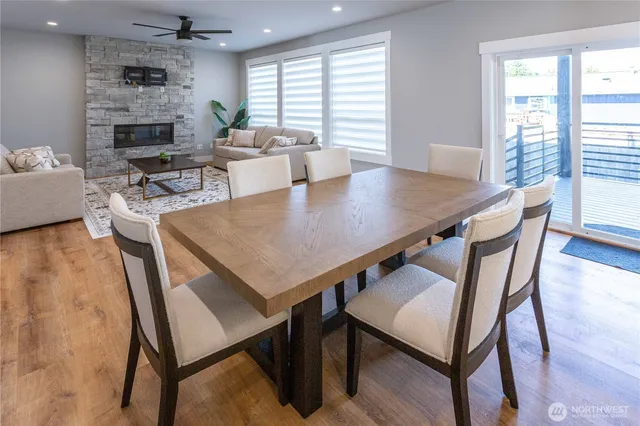 a living room with furniture wooden floor and kitchen view