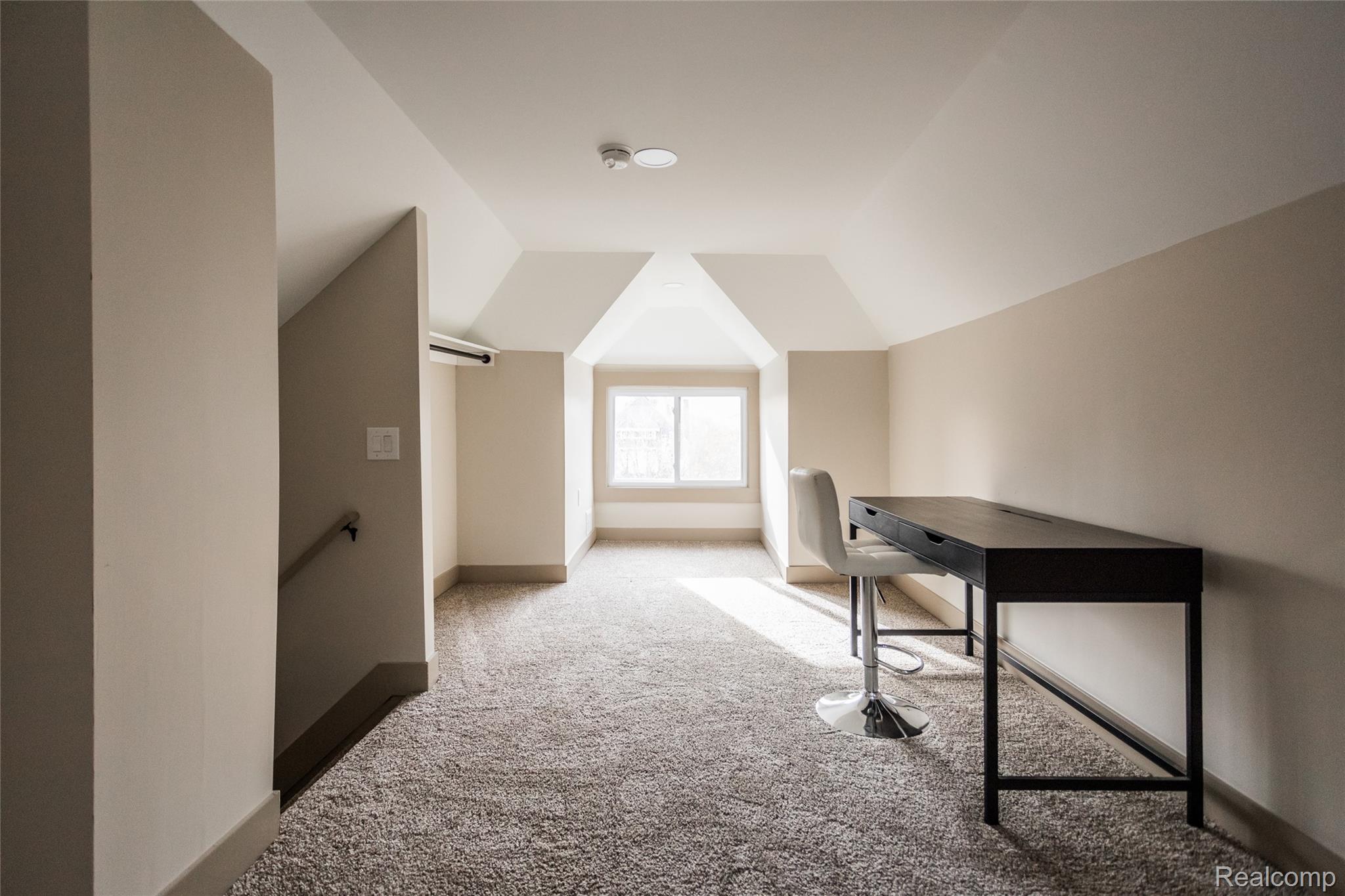 2630 Harding Street Detroit, MI 48214 - Photo 22 of 30 Carpeted loft area featuring sloped ceilings, a window, and neutral wall tones