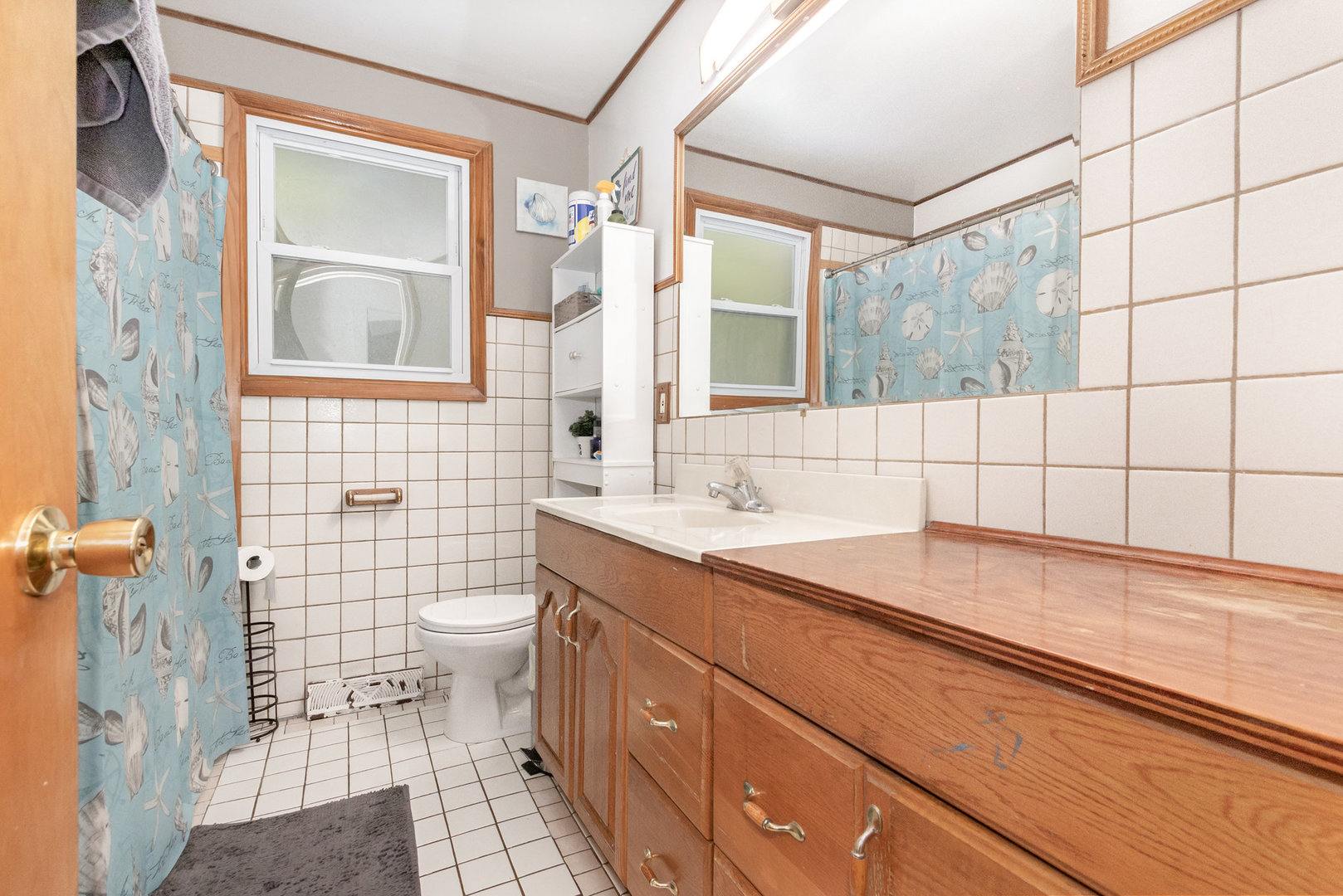 17518 Roy Street Lansing, IL 60438 - Photo 8 of 17 a bathroom with a sink a toilet a mirror and shower