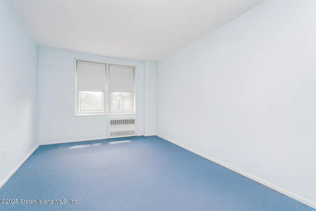 a bedroom with a large bed and a painting on the wall