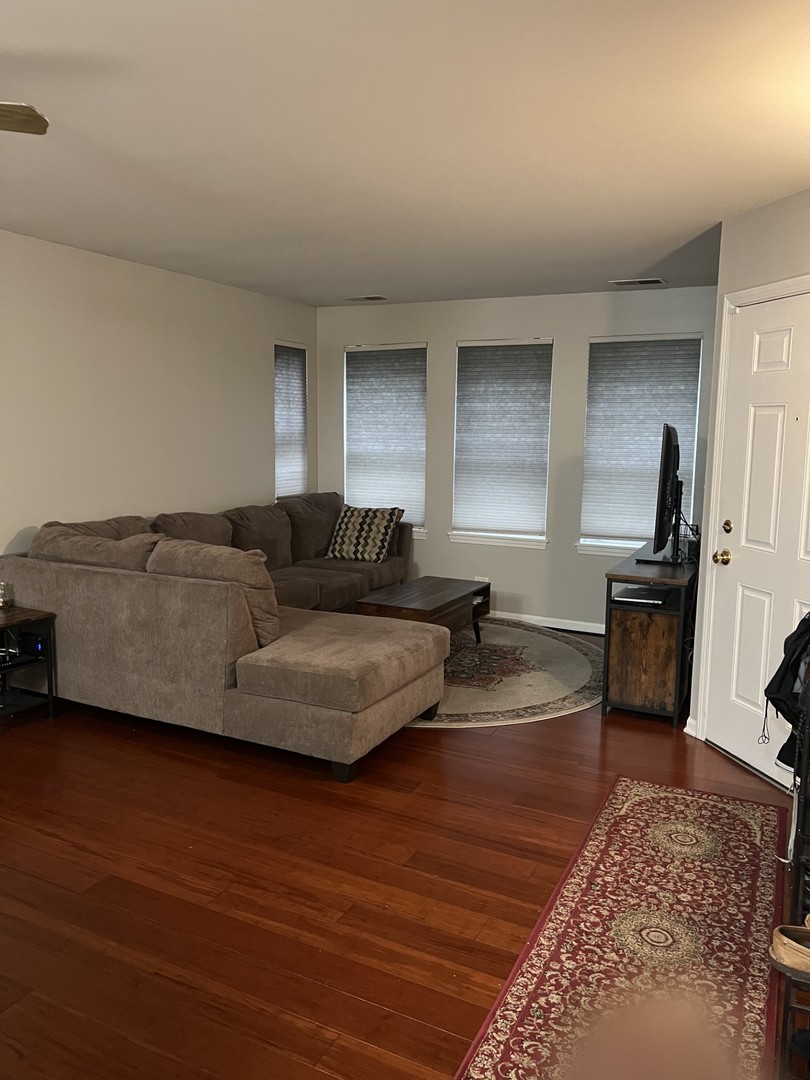 1148 North Howe Street, Unit B Chicago, IL 60610 - Photo 3 of 6 a living room with furniture and a wooden floor