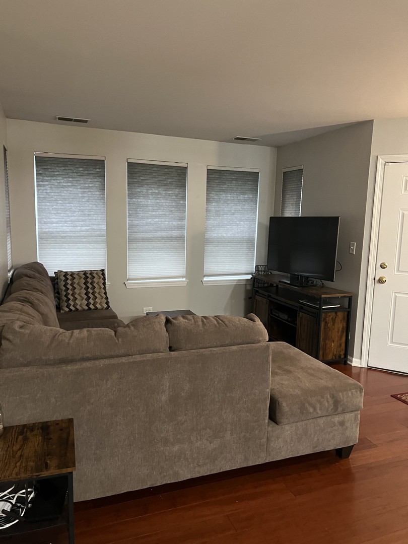 1148 North Howe Street, Unit B Chicago, IL 60610 - Photo 4 of 6 a living room with furniture and a flat screen tv