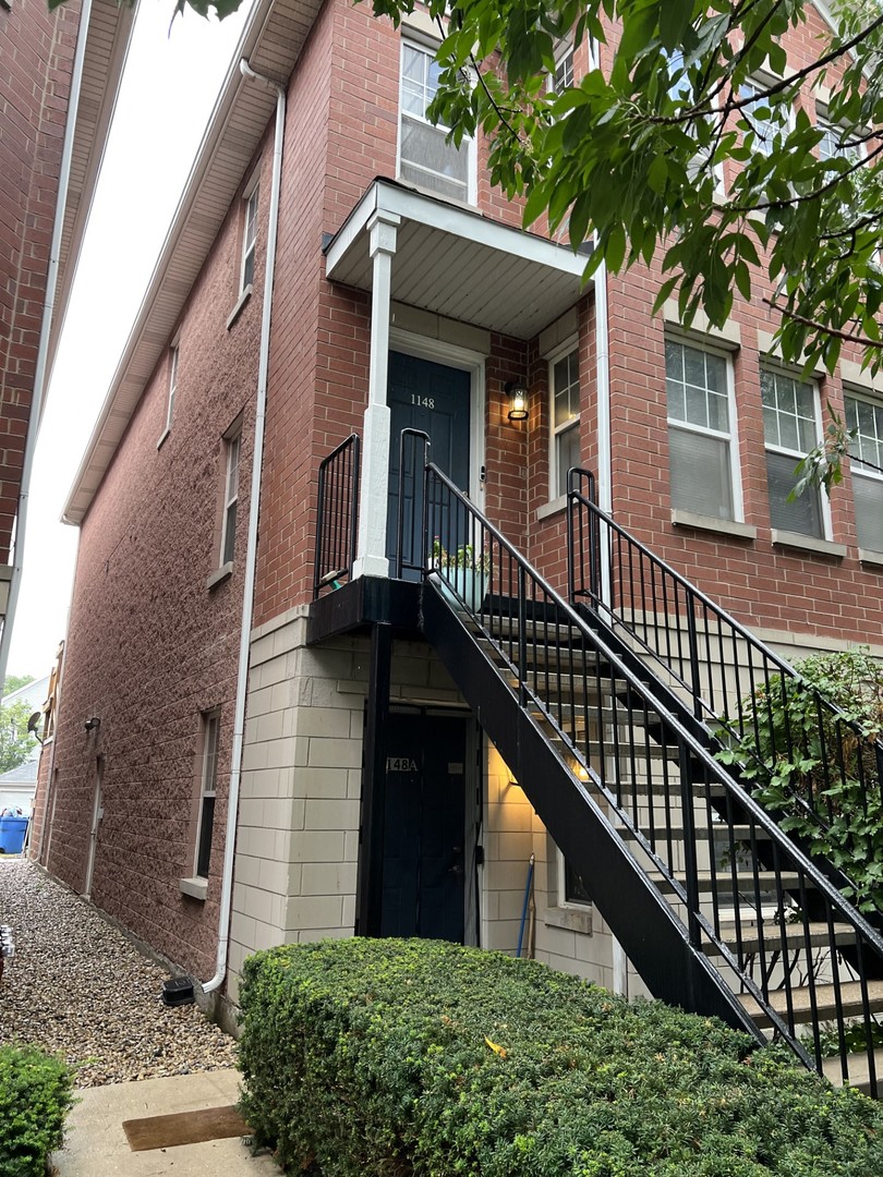 1148 North Howe Street, Unit B Chicago, IL 60610 - Photo 6 of 6 a view of a brick house with large windows