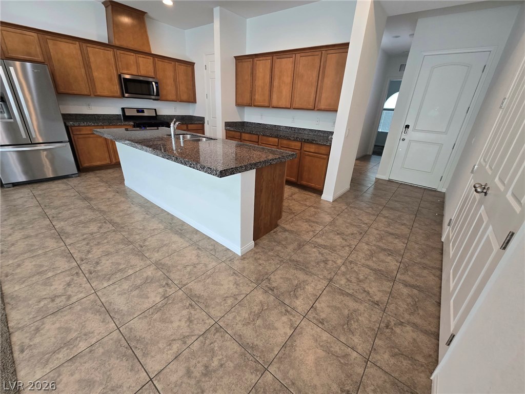 4748 Ritual Street North Las Vegas, NV 89031 - Photo 28 of 31 A well-appointed kitchen showcasing an island with sink and plenty of counter space for culinary endeavors.
