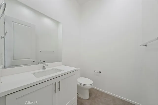 a bathroom with a sink mirror and toilet