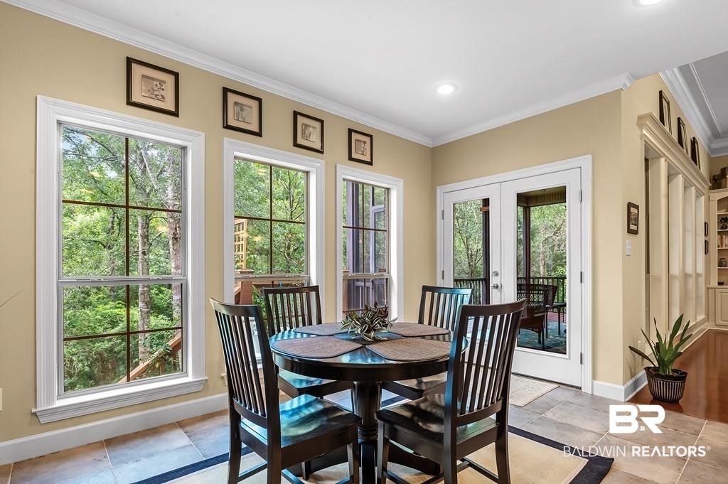 29976 Dolive Ridge Daphne, AL 36527 - Photo 20 of 58 Tiled dining room with ornamental molding and plenty of natural light