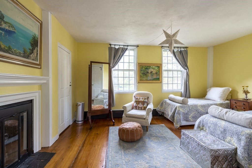 88 County Road Ipswich, MA 01938 - Photo 19 of 40 a bedroom with furniture and a fireplace