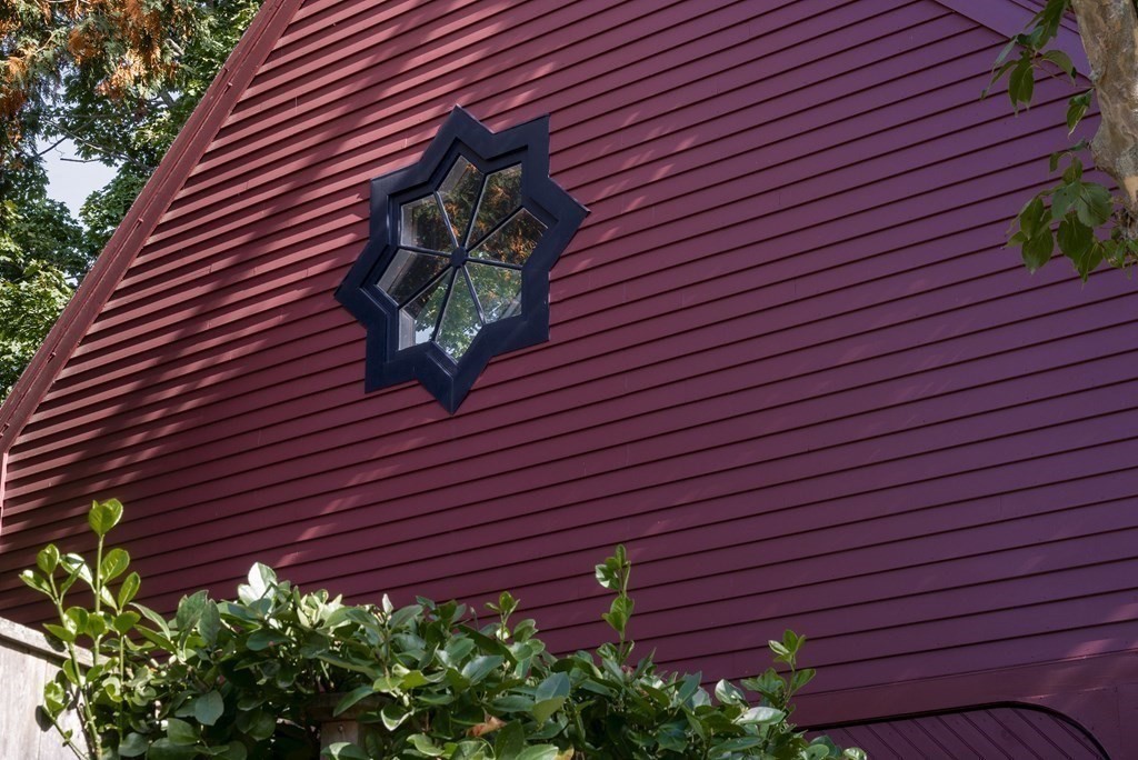 88 County Road Ipswich, MA 01938 - Photo 26 of 40 a view of a brick wall with plants and large trees