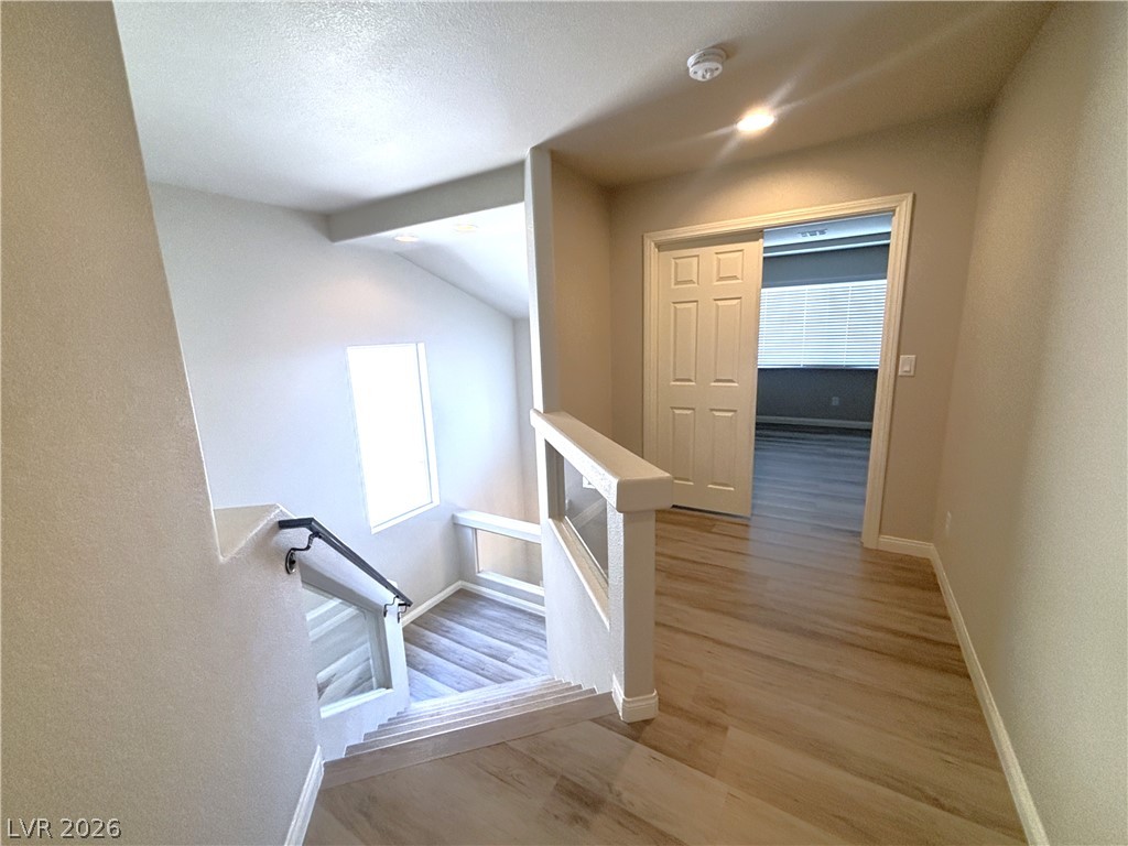 6425 Jackson Spring Road Las Vegas, NV 89118 - Photo 21 of 31 A split-level landing with wooden flooring guides the eye toward an inviting interior.