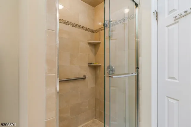 a bathroom with a glass shower door