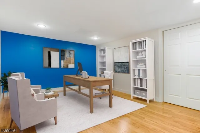 a living room with furniture a rug and kitchen view